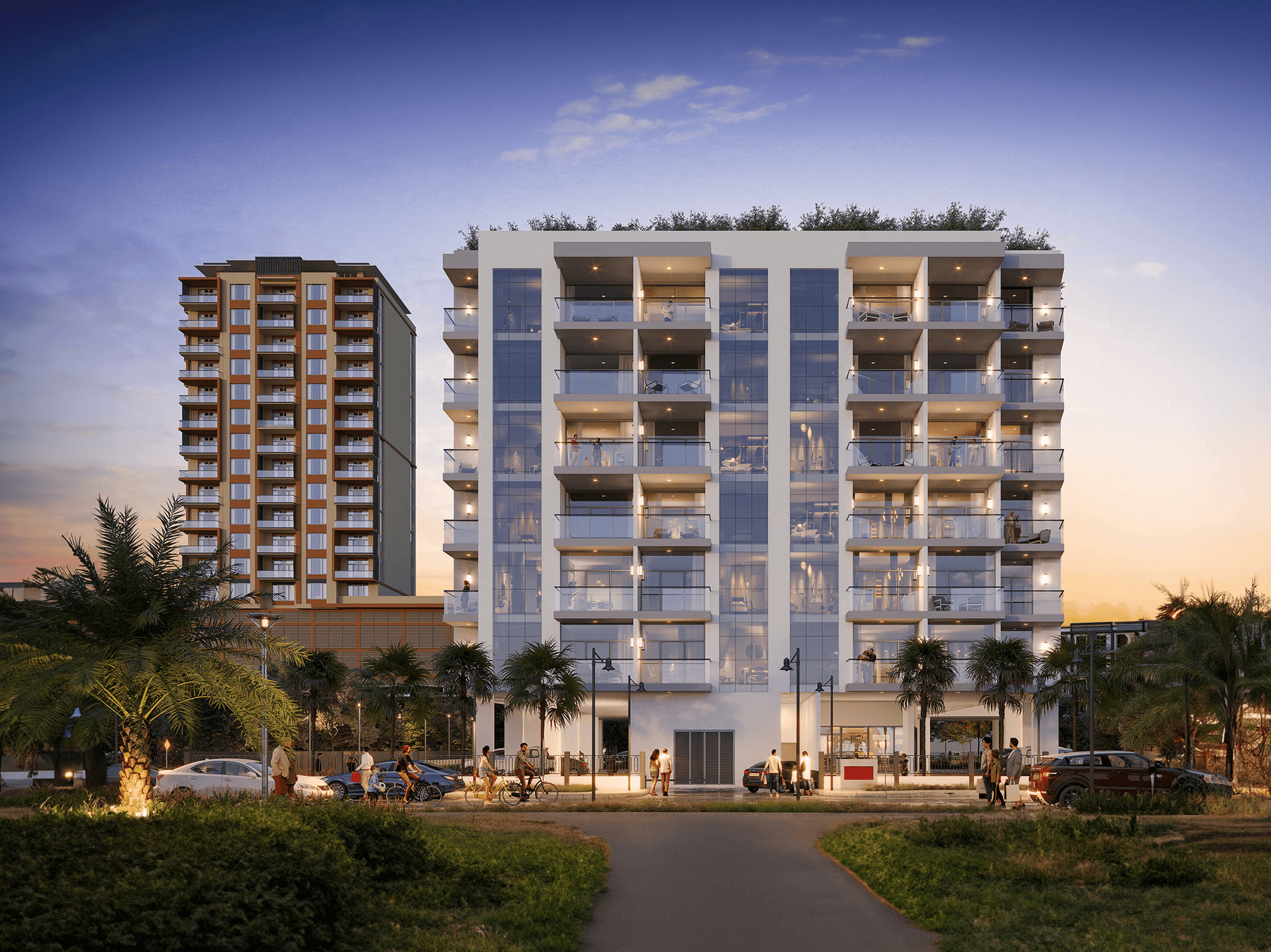Modern apartment buildings illuminated at dusk with palm trees and people in the foreground.